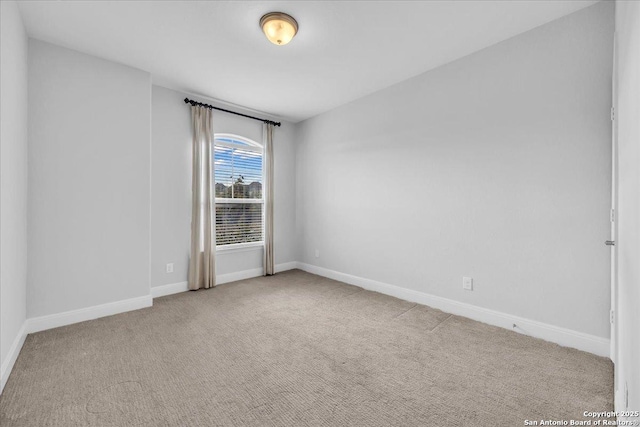 unfurnished room with light colored carpet