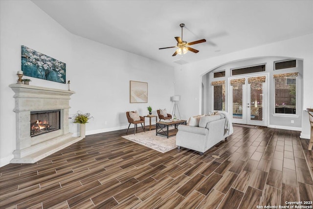 living room featuring a high end fireplace, french doors, and ceiling fan