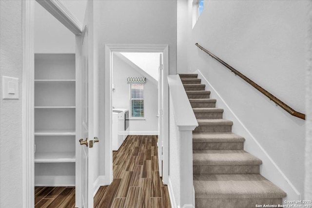 staircase with a wealth of natural light and washing machine and dryer