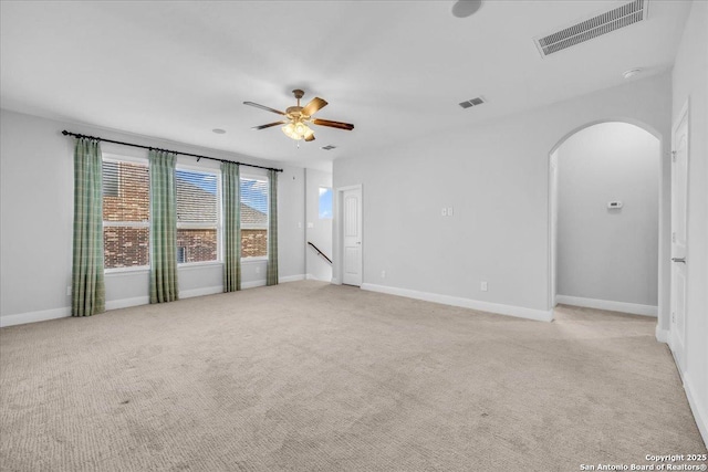 spare room with light carpet and ceiling fan