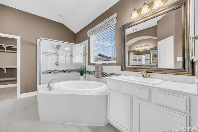 bathroom with vanity, vaulted ceiling, tile patterned floors, and independent shower and bath