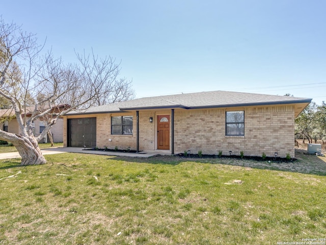 single story home featuring a front lawn, an attached garage, brick siding, and driveway