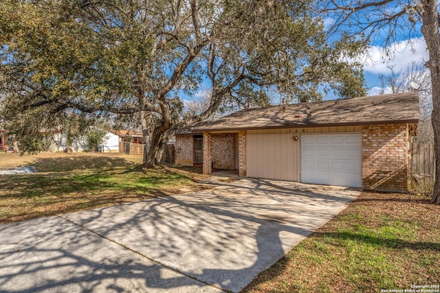 ranch-style home featuring a garage and a front lawn