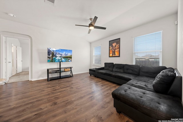 living room with dark wood-type flooring, ceiling fan, and vaulted ceiling