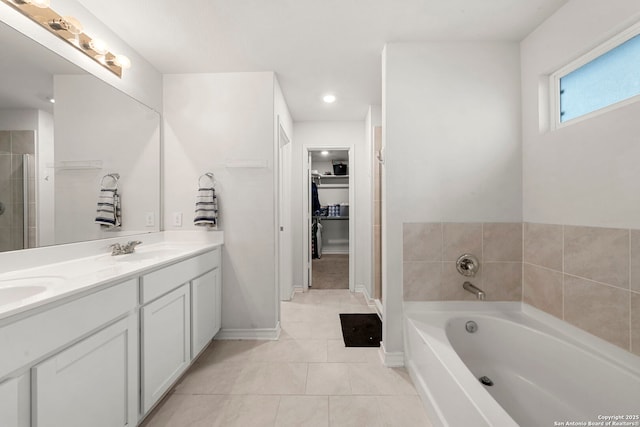 bathroom with vanity, tile patterned floors, and a tub