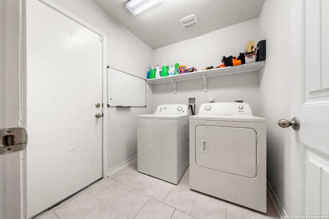 washroom with light tile patterned floors and independent washer and dryer