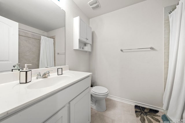 bathroom featuring vanity, tile patterned flooring, toilet, and walk in shower