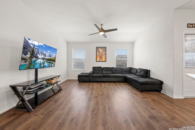 living room featuring dark wood-type flooring, a wealth of natural light, and ceiling fan