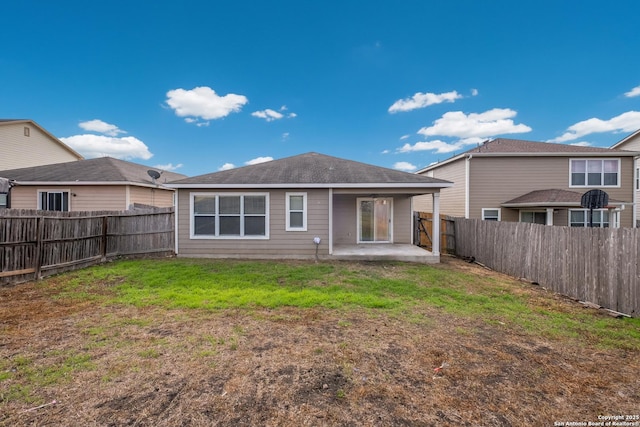 back of house with a yard, a patio area, and a fenced backyard