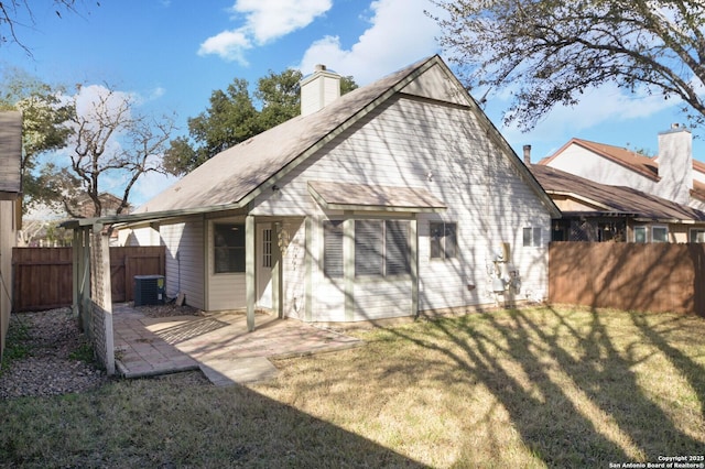 rear view of house with a yard and a patio area