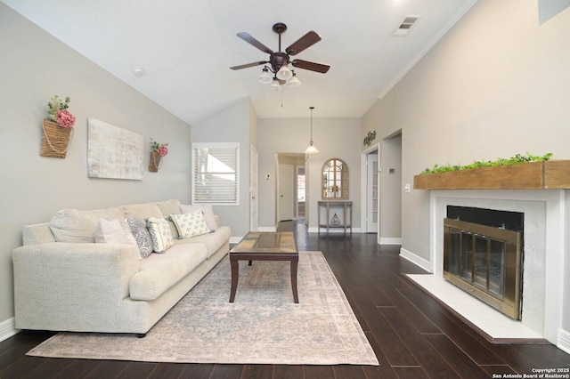 living room featuring dark hardwood / wood-style flooring, vaulted ceiling, and ceiling fan