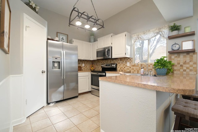 kitchen featuring white cabinetry, appliances with stainless steel finishes, sink, and pendant lighting