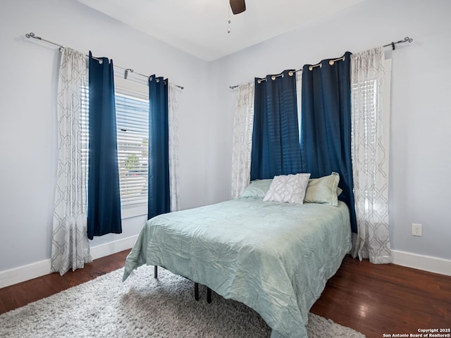 bedroom featuring ceiling fan and dark hardwood / wood-style floors