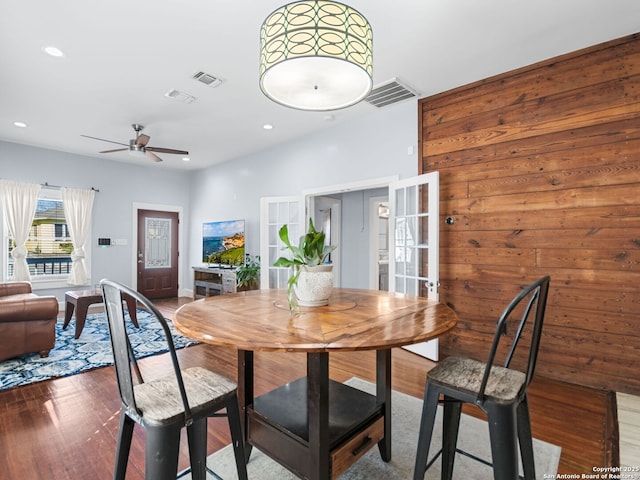 dining space with hardwood / wood-style floors and ceiling fan