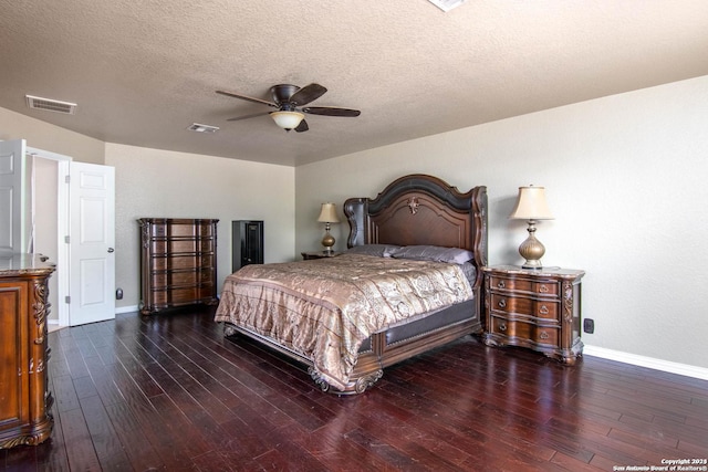 bedroom with ceiling fan, dark hardwood / wood-style floors, and a textured ceiling