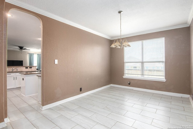 empty room with ornamental molding, ceiling fan with notable chandelier, and light tile patterned floors