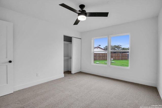 unfurnished bedroom with ceiling fan, carpet floors, and a closet