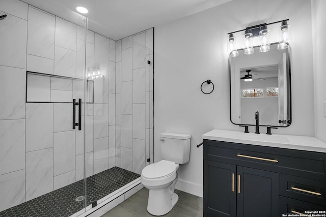 bathroom with vanity, a shower with shower door, and toilet