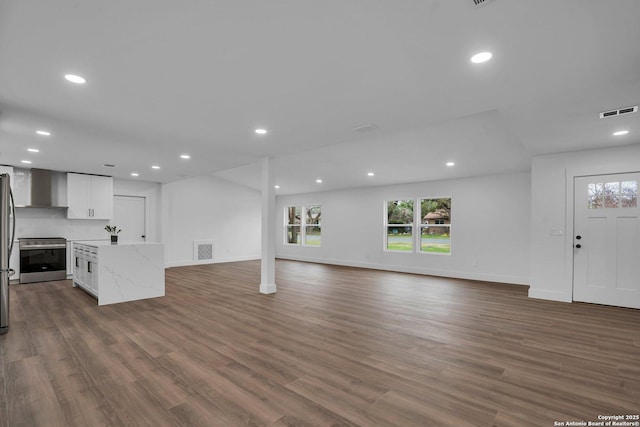 unfurnished living room with dark hardwood / wood-style floors