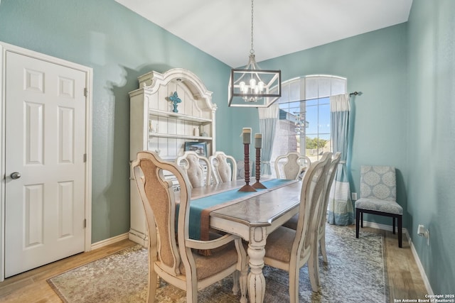 dining area featuring hardwood / wood-style floors and a notable chandelier