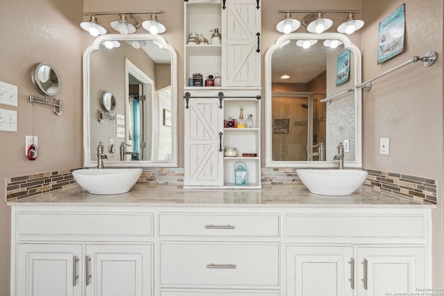 bathroom with tasteful backsplash, vanity, and a shower with shower door