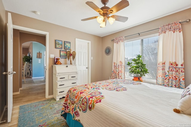 bedroom with ceiling fan and light wood-type flooring