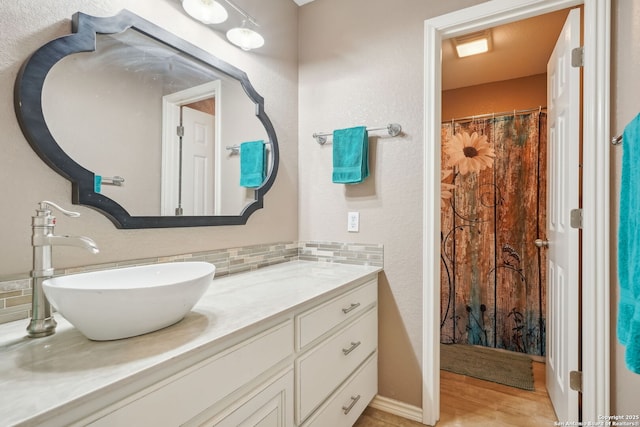 bathroom with vanity and decorative backsplash