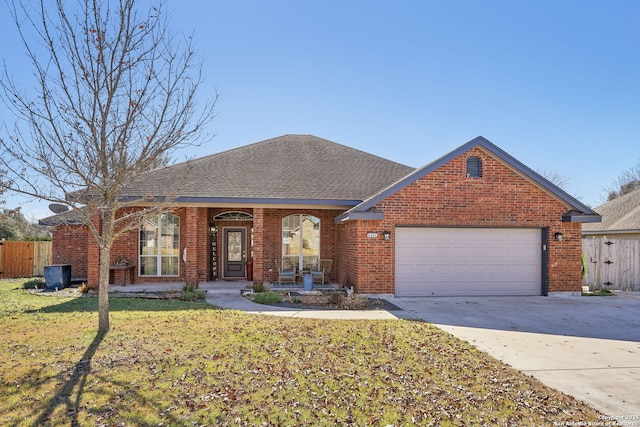 single story home with a garage and a front lawn