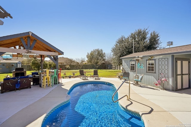 view of swimming pool featuring an outdoor structure, a yard, grilling area, a gazebo, and a patio area