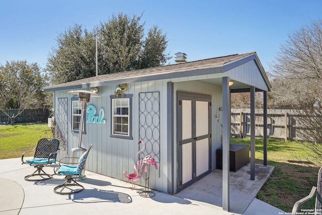 view of outbuilding featuring a lawn