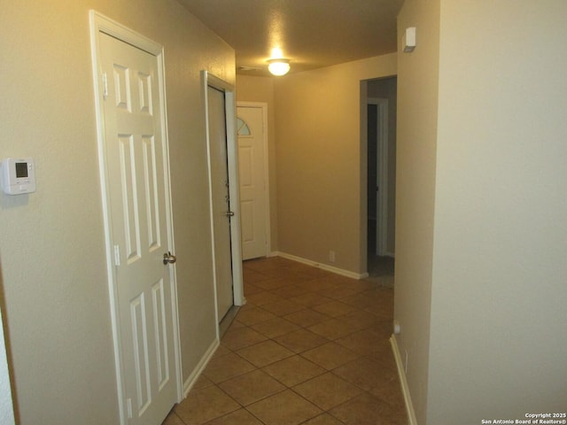 corridor featuring light tile patterned floors