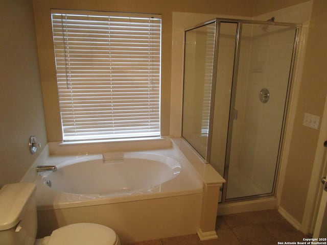 bathroom featuring shower with separate bathtub, tile patterned floors, and toilet