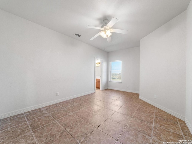 spare room featuring tile patterned flooring and ceiling fan