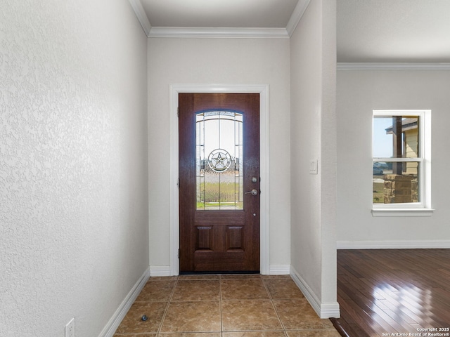 tiled entrance foyer featuring crown molding