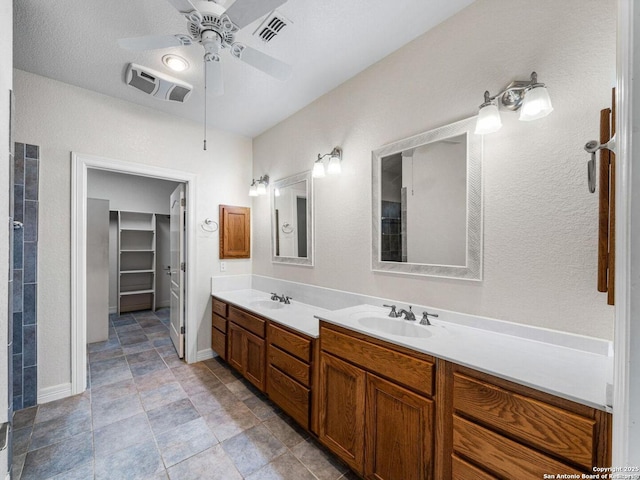 bathroom with ceiling fan and vanity