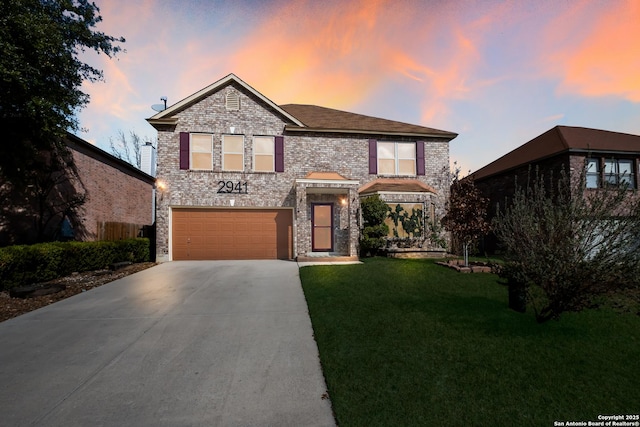 front of property featuring a garage and a lawn