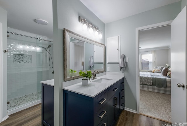 bathroom with vanity, hardwood / wood-style floors, and walk in shower