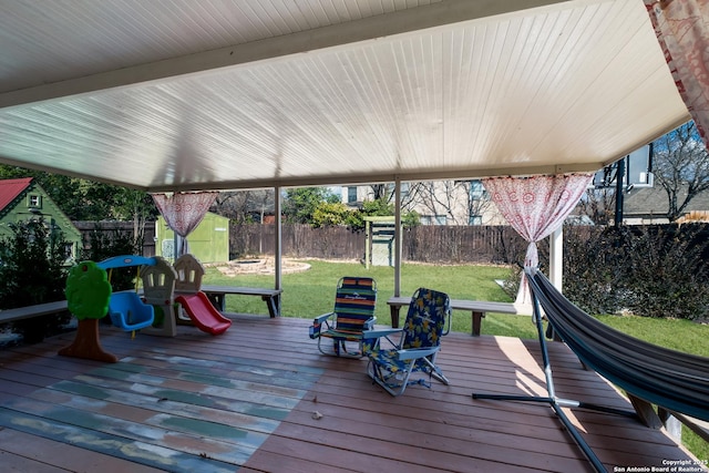 wooden terrace featuring a yard