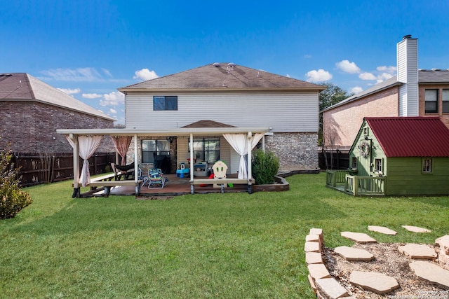 rear view of house featuring a storage shed, a lawn, and a patio