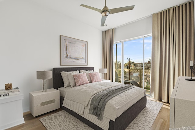 bedroom with access to outside, ceiling fan, and wood finished floors