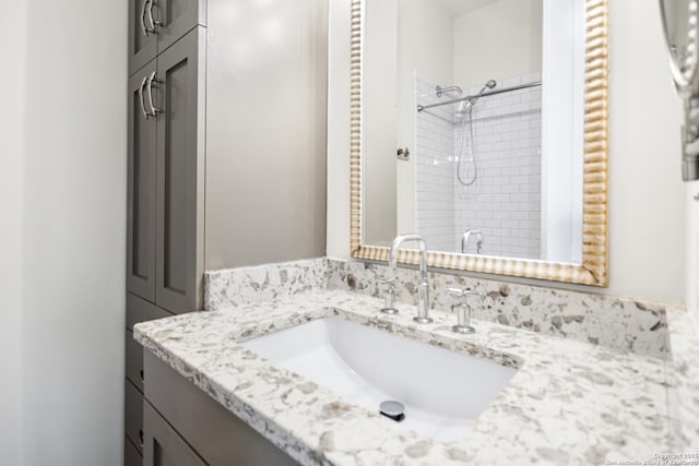 bathroom with a shower and vanity