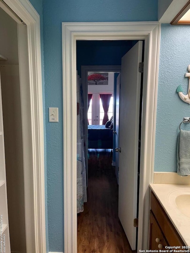 hallway featuring dark wood-type flooring and french doors