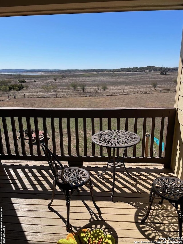 wooden deck featuring a lawn