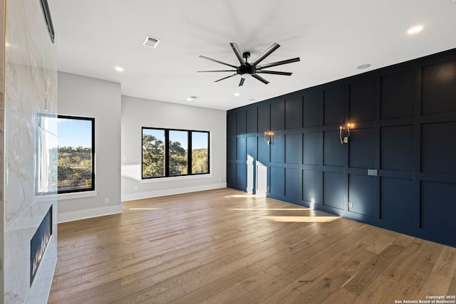 unfurnished living room with ceiling fan and light wood-type flooring