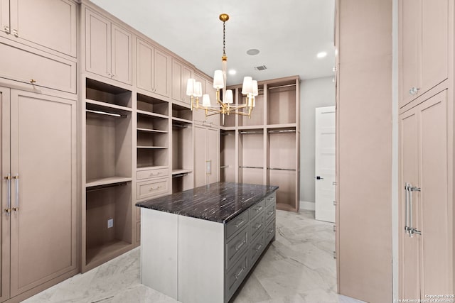 walk in closet featuring an inviting chandelier