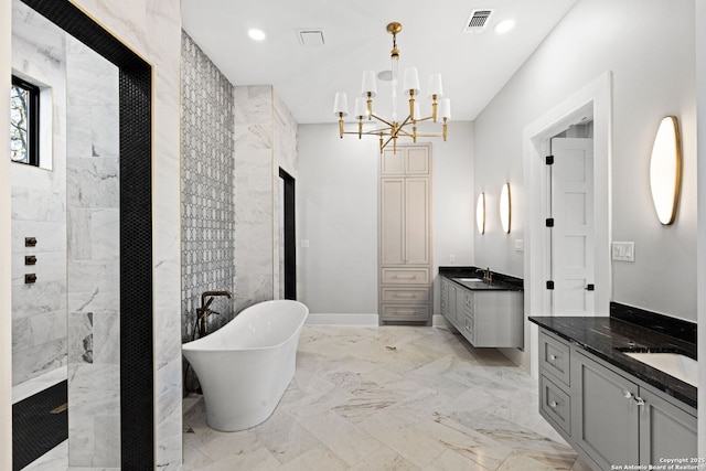 bathroom with a chandelier, vanity, and independent shower and bath