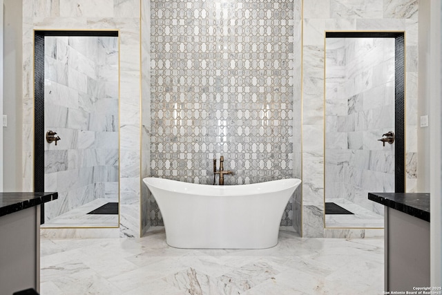 bathroom with vanity, separate shower and tub, and tile walls