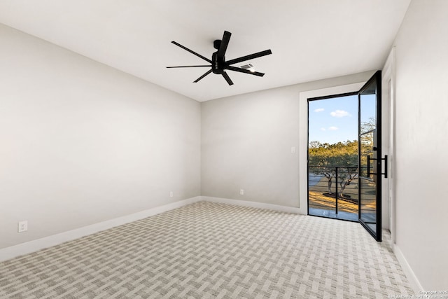 unfurnished room with ceiling fan and light carpet