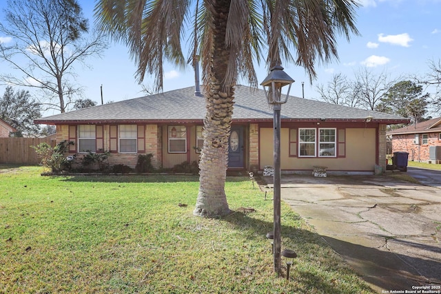 ranch-style home with central AC unit and a front yard