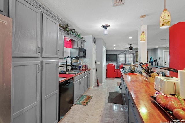 kitchen featuring gray cabinets, pendant lighting, sink, butcher block counters, and black appliances